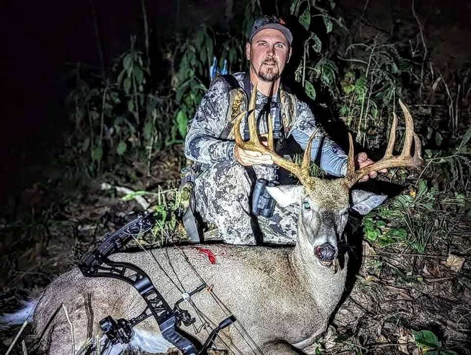 Bowhunter with a mature Ohio whitetail taken after dark