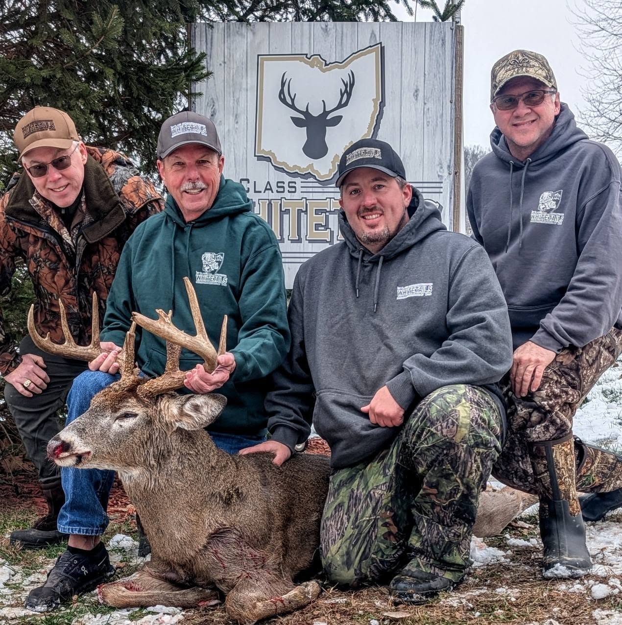 Hunters with a trophy Ohio whitetail buck at 1st Class Whitetails